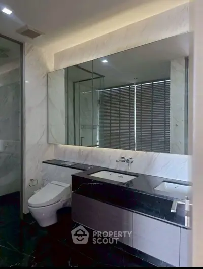 Luxurious modern bathroom with dual sinks and elegant marble finishes.