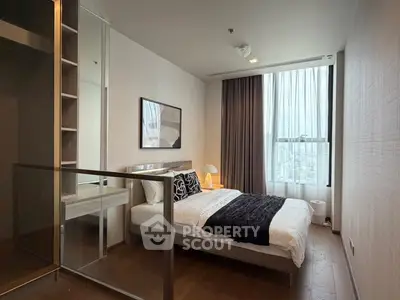 Modern bedroom with large window and stylish decor in a high-rise apartment.