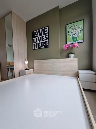 Modern bedroom with stylish decor and wooden furniture, featuring a cozy ambiance and elegant wall art.