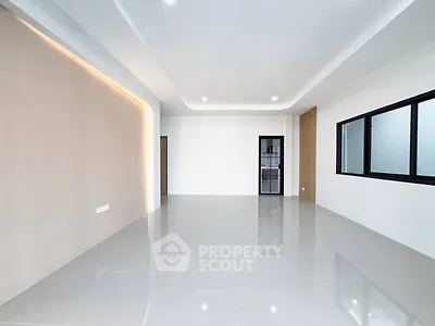 Spacious modern living room with sleek tile flooring and large windows