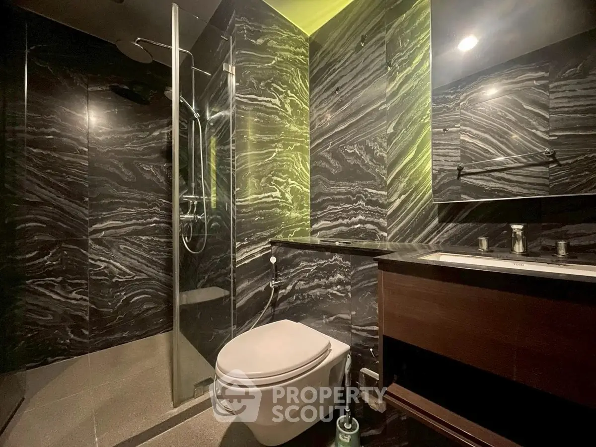 Luxurious modern bathroom with sleek black marble walls and elegant fixtures