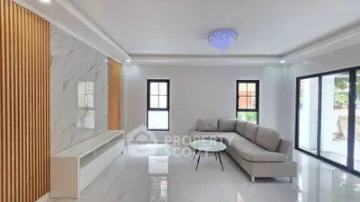 Spacious modern living room with elegant marble flooring and stylish chandelier