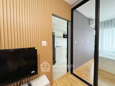 Modern apartment interior with wooden paneling and open kitchen layout