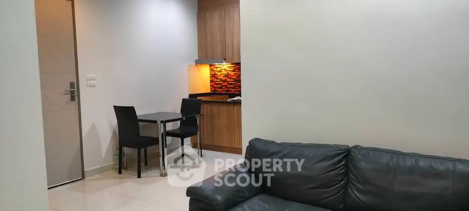 Modern apartment interior with cozy living room and compact kitchen area featuring stylish decor.