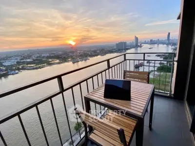 Stunning river view from high-rise balcony with sunset backdrop