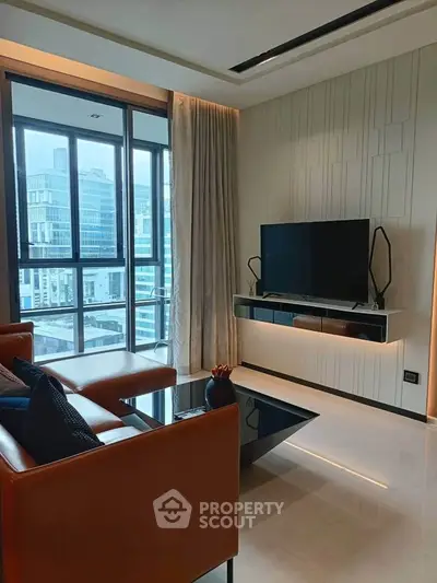 Modern living room with sleek design and city view, featuring a wall-mounted TV and elegant furnishings.