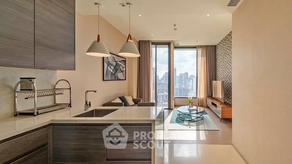 Modern open-plan kitchen and living room with city view, stylish decor, and ample natural light.
