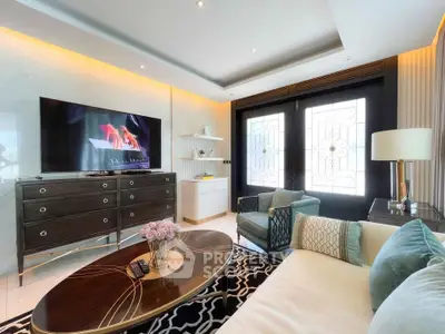 Luxurious living room with elegant decor, large TV, and stylish furniture in a modern home.