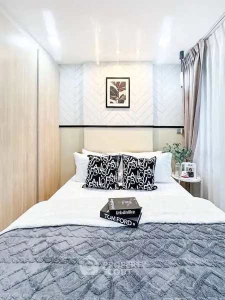 Modern bedroom with stylish decor and cozy bedding in a chic apartment.