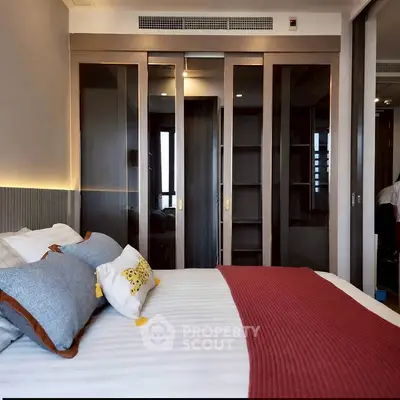 Luxurious bedroom with modern design and elegant decor, featuring a spacious wardrobe and cozy bedding.