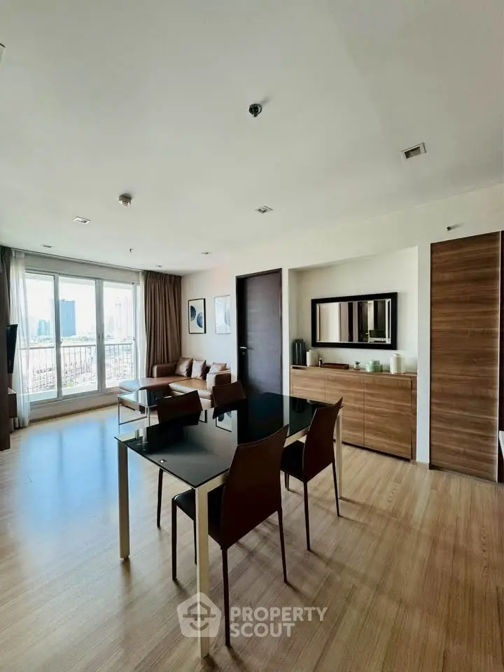 Spacious modern living room with elegant dining area and city view.