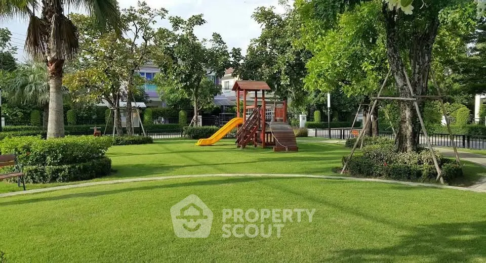 Beautiful garden with playground in a residential community, perfect for family living.