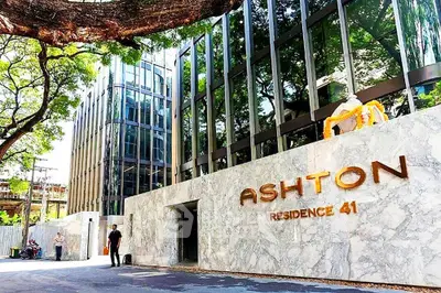 Luxurious modern building exterior with sleek glass facade and elegant marble entrance at Ashton Residence 41.