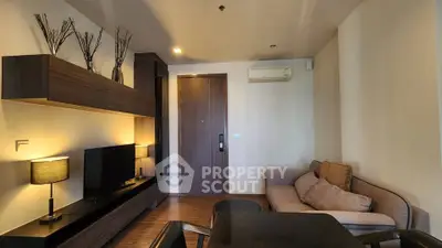 Modern living room with stylish furniture and ambient lighting, perfect for relaxation and entertainment.