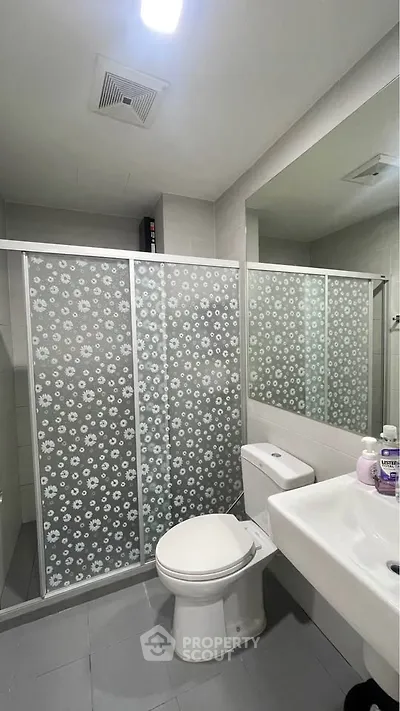 Modern bathroom with floral shower screen and sleek fixtures