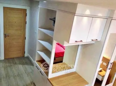 Modern apartment interior with stylish wooden cabinetry and sleek design.