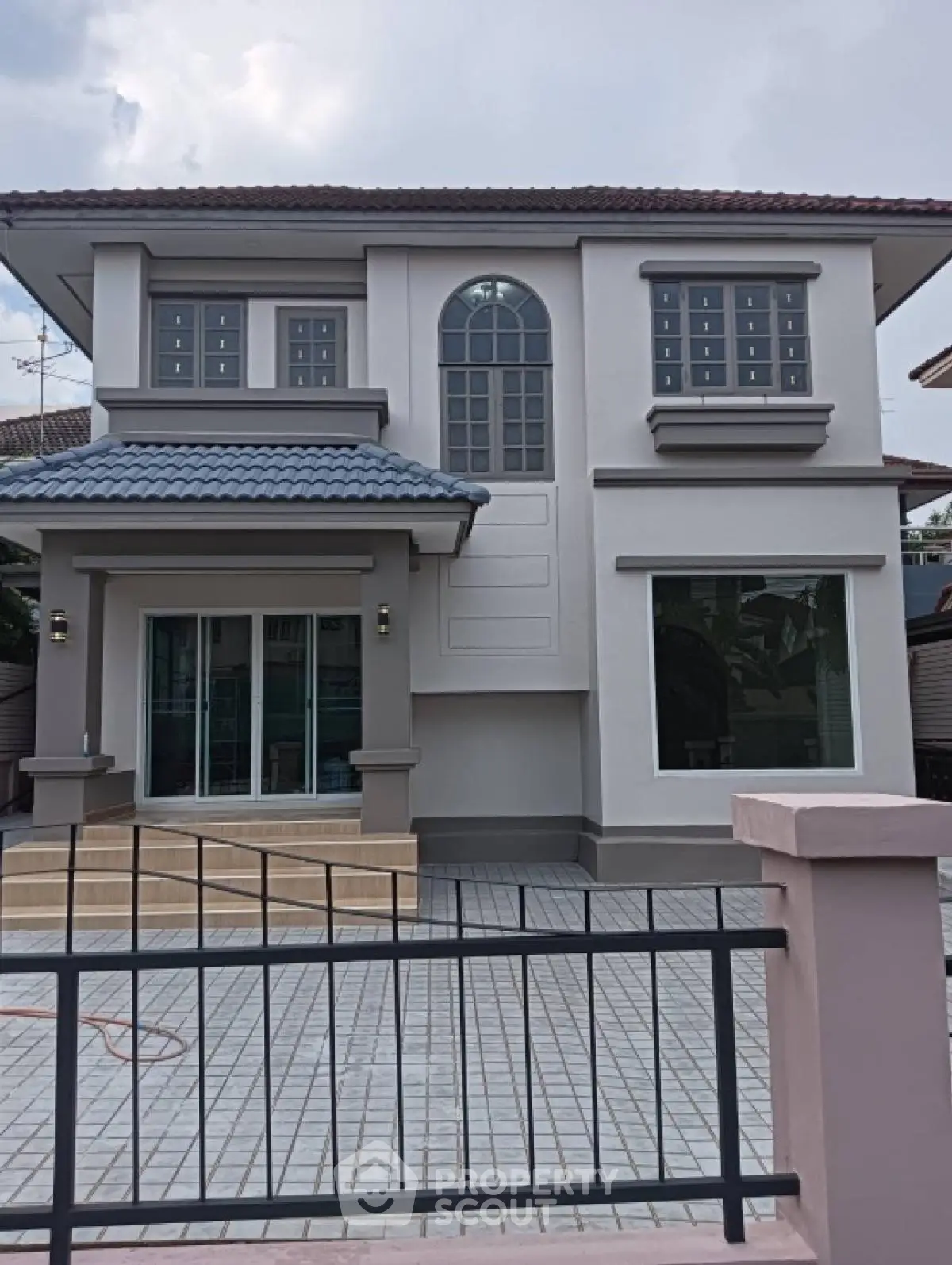 Elegant two-story house with modern design and spacious windows