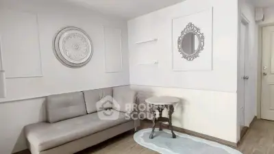 Chic living room with elegant decor and cozy seating in modern apartment.