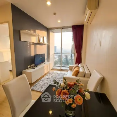 Modern living room with city view, stylish furniture, and elegant decor in a high-rise apartment.