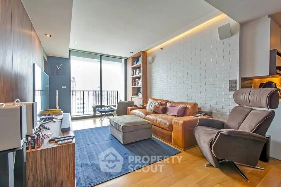 Modern living room with stylish furniture and balcony access