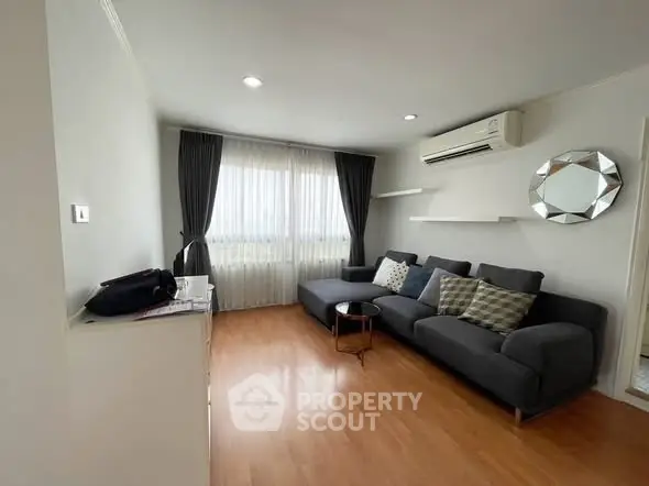 Modern living room with stylish gray sofa and air conditioning