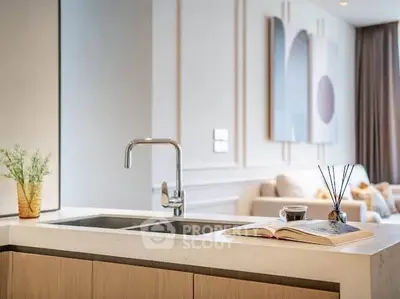 Modern kitchen with sleek design and open layout, featuring a stylish faucet and elegant decor.