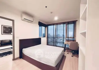 Modern bedroom with city view, featuring a sleek design and ample natural light, perfect for urban living.