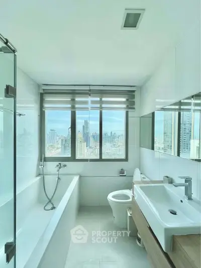 Modern bathroom with city view, featuring sleek fixtures and a large window.