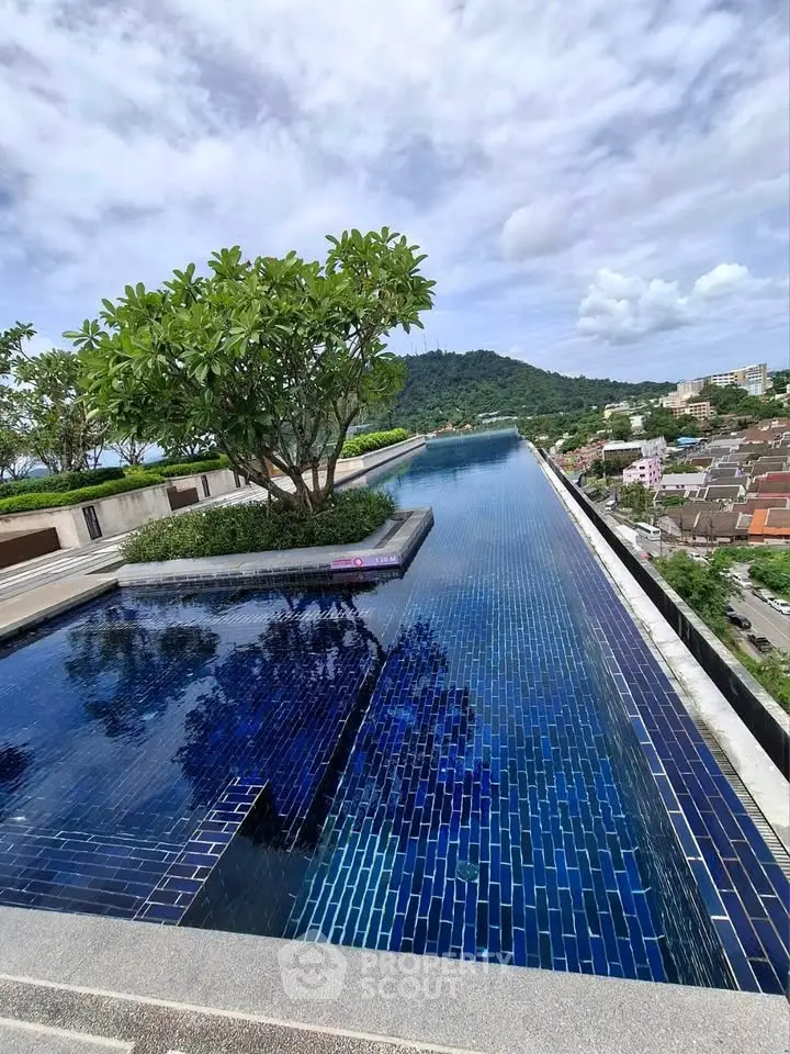 Stunning rooftop infinity pool with panoramic mountain and city views.