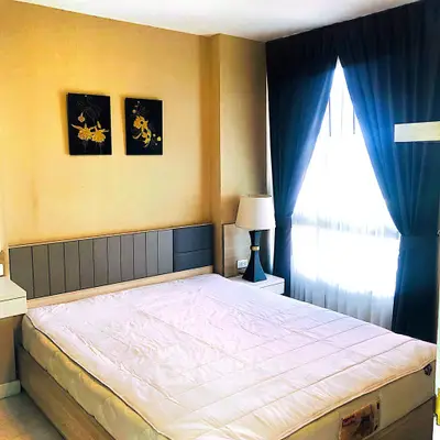 Elegant bedroom with modern decor, large window, and stylish furnishings for a cozy living experience.