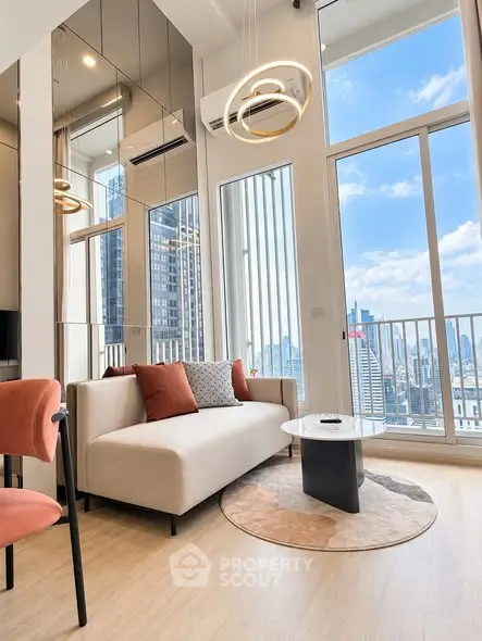 Modern living room with floor-to-ceiling windows and city view, featuring stylish furniture and elegant lighting.