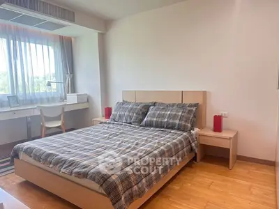 Modern bedroom with stylish decor and natural light, featuring a cozy bed and functional workspace.