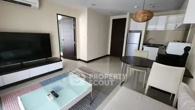 Modern living room with open kitchen, sleek furniture, and stylish decor