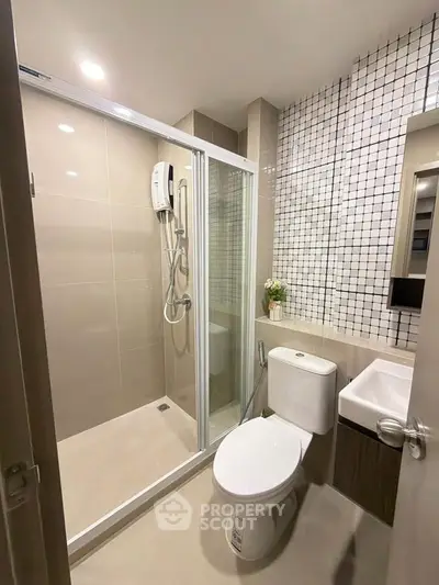 Modern bathroom with glass shower enclosure and stylish tile design