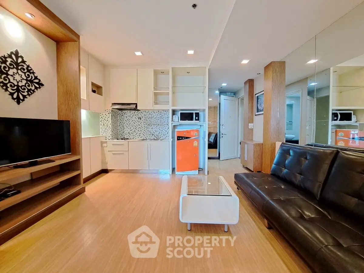 Modern living room with sleek furniture and open kitchen layout