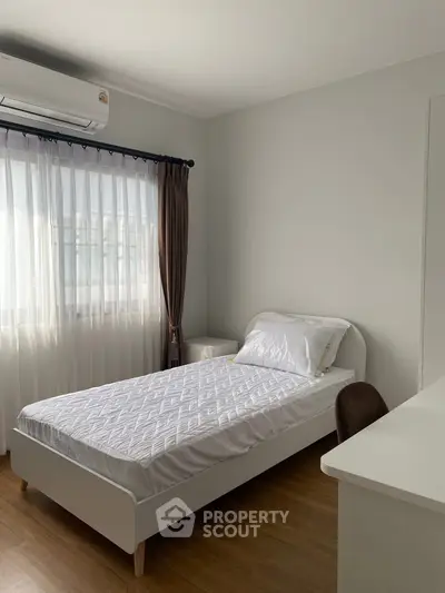 Cozy minimalist bedroom with natural light and modern furnishings