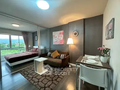 Modern studio apartment with cozy living area and scenic view