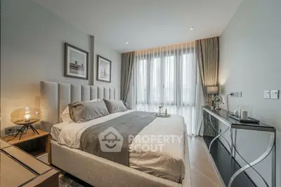 Luxurious modern bedroom with elegant decor and large window for natural light.