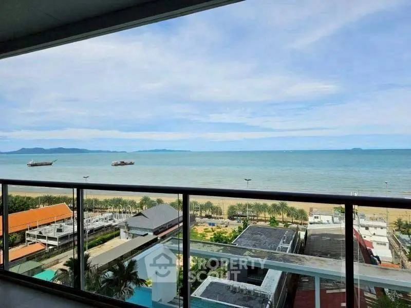 Stunning ocean view from a high-rise balcony overlooking the beach and horizon.