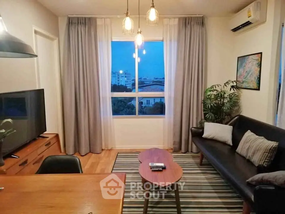 Cozy living room with modern decor, large window, and stylish lighting.