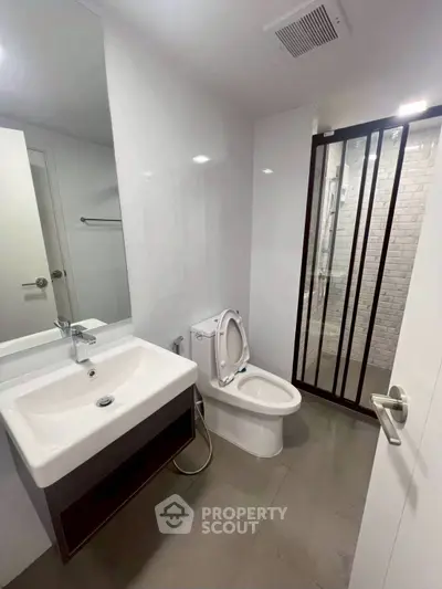 Modern bathroom with sleek fixtures and glass shower enclosure