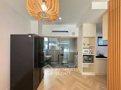 Modern kitchen with sleek appliances and stylish lighting in a contemporary apartment.