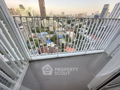 Stunning city view from high-rise balcony with modern railing.