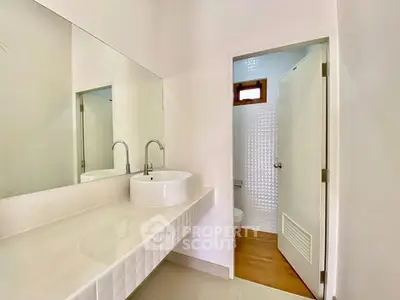 Modern bathroom with sleek white sink and minimalist design