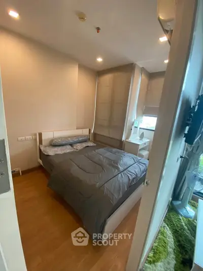 Cozy bedroom with modern decor and ample natural light, perfect for relaxation.