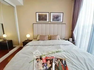 Elegant bedroom with stylish decor and cozy ambiance, featuring a plush bed and modern lighting.