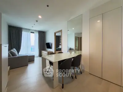 Modern living room with dining area, sleek furniture, and large window with city view.