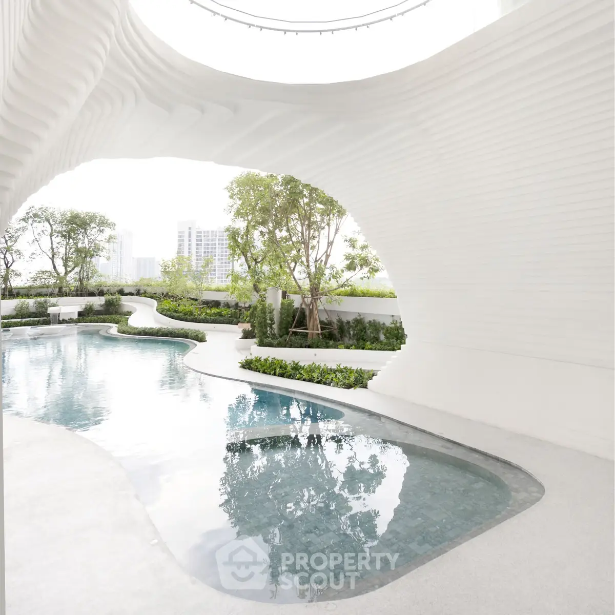 Luxurious modern pool with unique architectural design and lush greenery