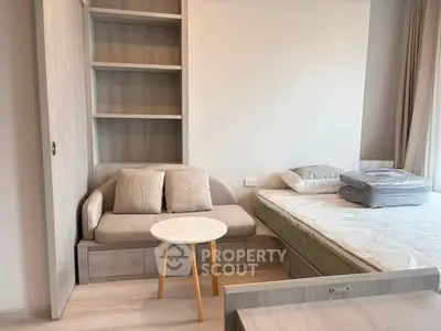 Cozy bedroom with modern furniture and built-in shelving, perfect for urban living.
