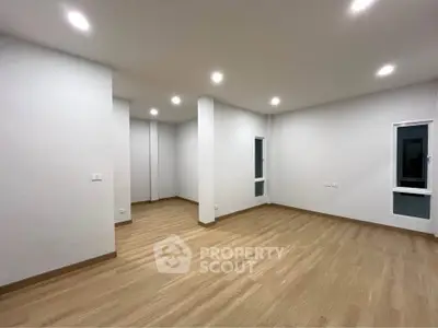 Spacious modern living room with wooden flooring and recessed lighting